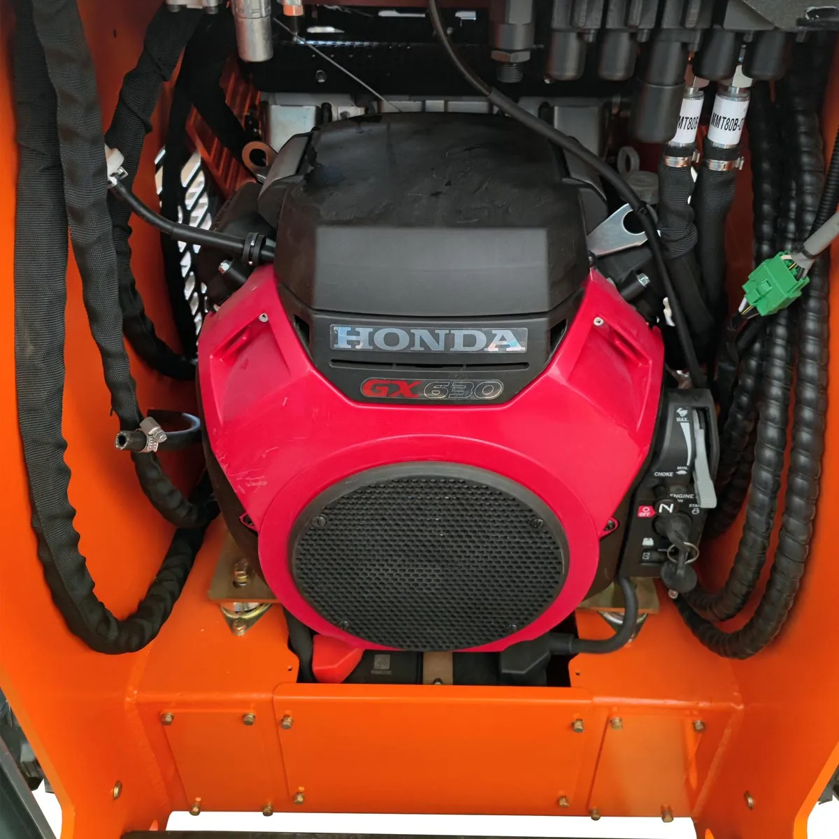 Compact and Powerful TMG Industrial 22 HP Honda Engine Stand-On Mini Track Loader - 750 lb Capacity with Eaton Hydraulic Motor, Permco Pump, Italian Hydro Control Valve, Joystick Controls, and Smooth Bucket (Model TMG-MVL22H)